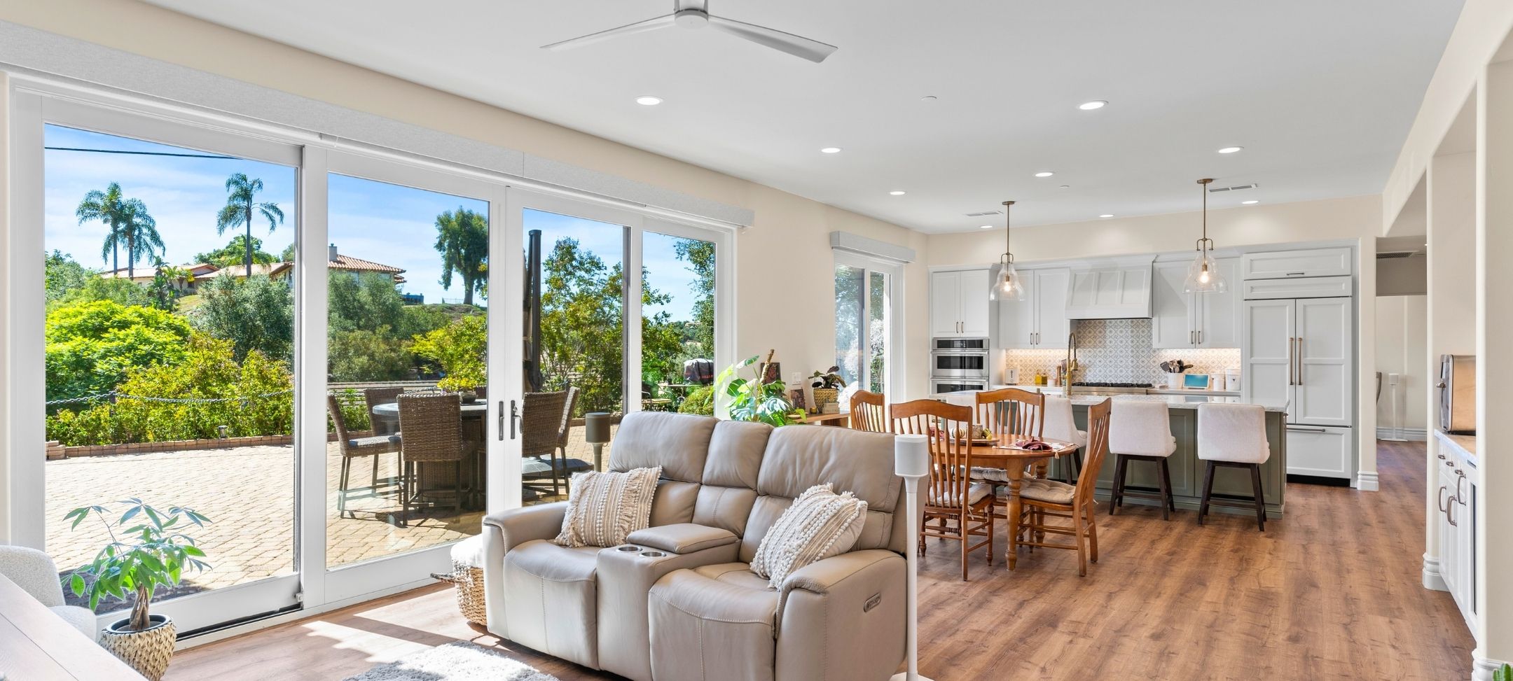 Open-concept ADU living, dining, and kitchen with sliding glass doors to a private patio