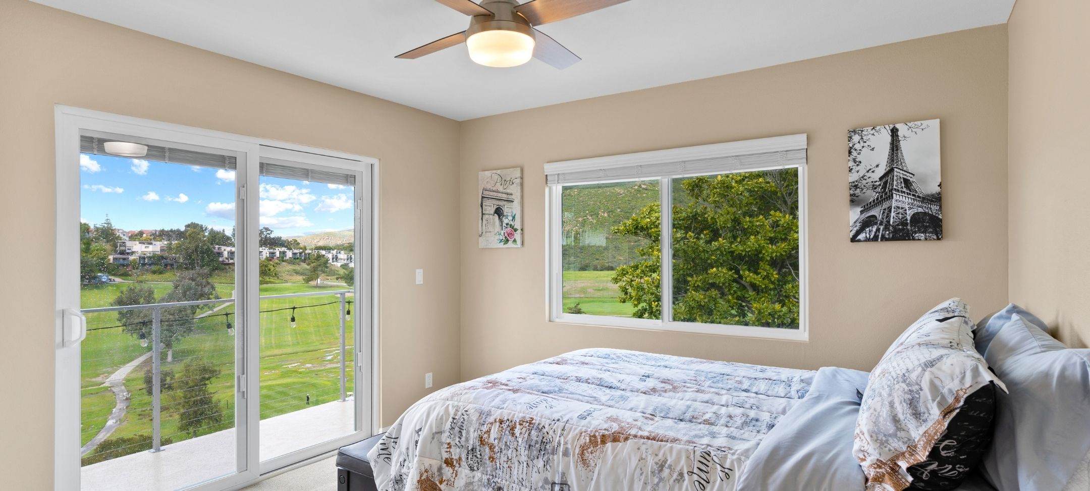 ADU bedroom with sliding glass door balcony access and golf course views