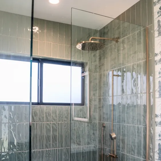 San Diego walk-in shower remodel with rainfall and handheld shower systems, frameless glass, and green tile