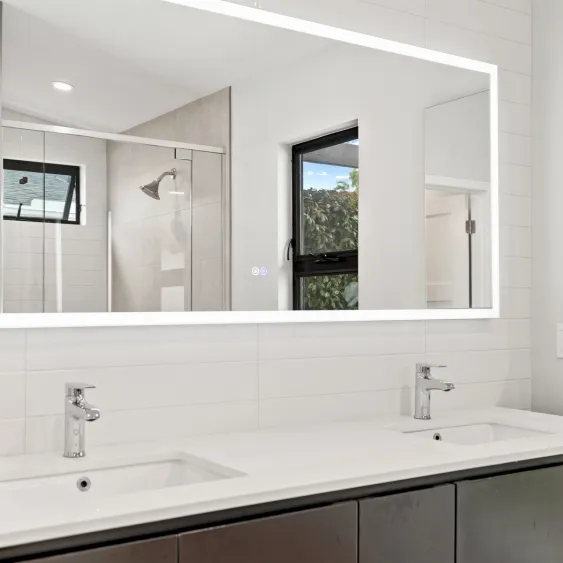 High-end San Diego bathroom remodel with a smart lighted mirror and modern double vanity