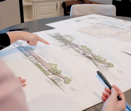 Lars team members review remodeling plans at a table.