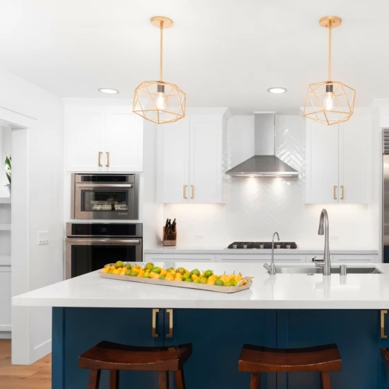 San Diego kitchen remodel with white cabinetry, a navy island, pendant lighting, and bar seating