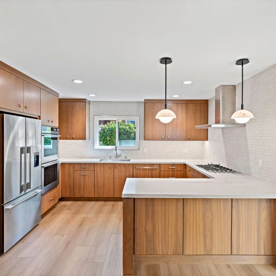 Natural wood cabinet finish with white countertops in a San Diego kitchen remodel