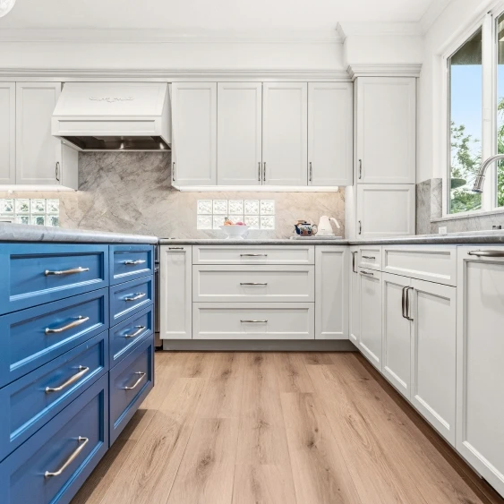 Custom white and blue kitchen cabinetry with integrated storage in a San Diego remodel
