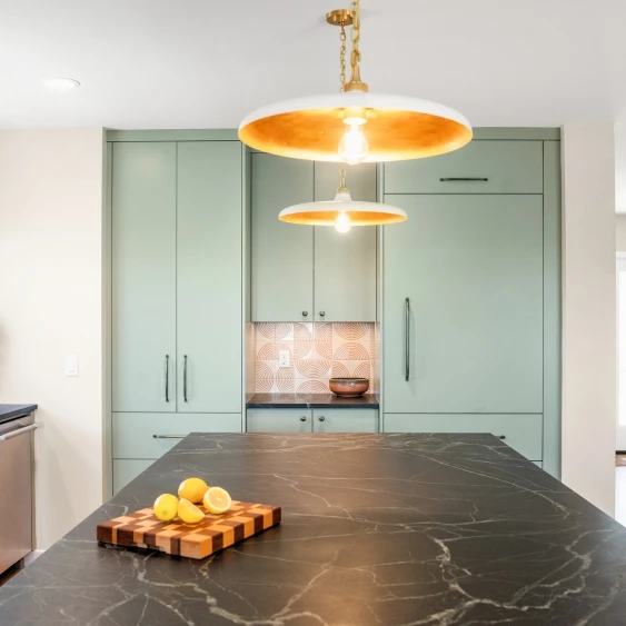 Veined quartz kitchen countertop with green cabinetry in a San Diego kitchen remodel