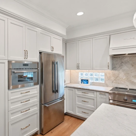 Built-in stainless kitchen appliances with custom white cabinetry in a San Diego remodel