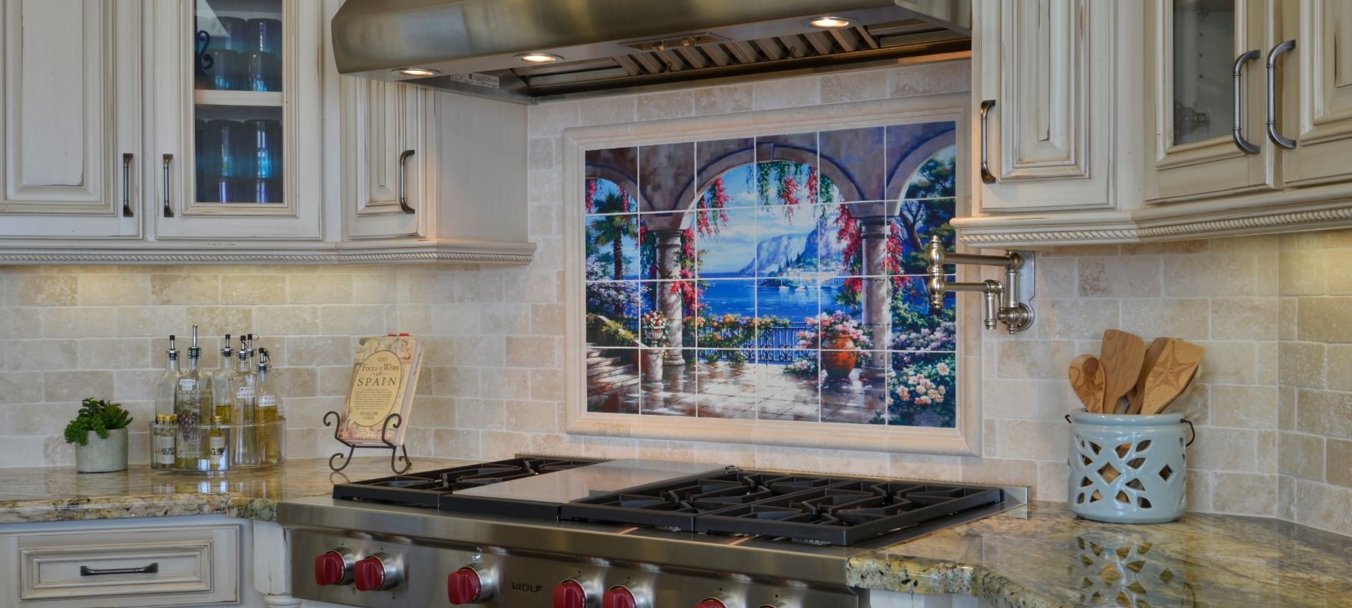 Traditional kitchen remodel with hand-painted tile mural backsplash, pot filler, and granite countertops