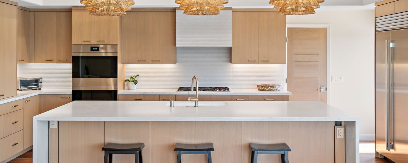 Completed Lars kitchen with installed cabinetry, countertops, appliances, lighting, and finish details