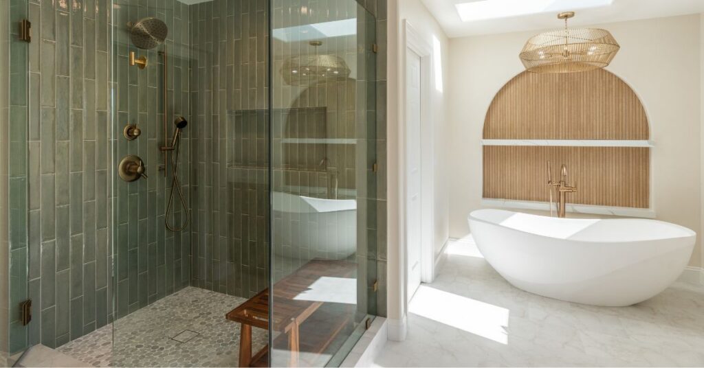 Luxury bathroom featuring a freestanding soaking tub, green vertical tile shower, brass fixtures, and spa-inspired design elements.