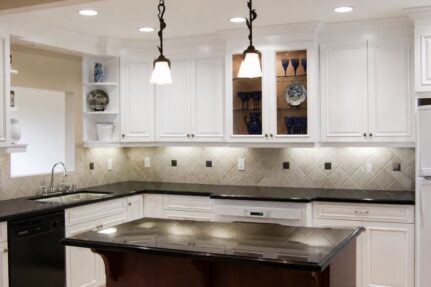 Custom kitchen remodel in La Mesa featuring white shaker cabinets, black stone countertops, a spacious island, and timeless design-build craftsmanship.