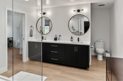 Luxury bathroom remodel featuring a frameless glass shower enclosure, custom dual vanity, and modern finishes that highlight the beauty and openness glass can bring to a home renovation.