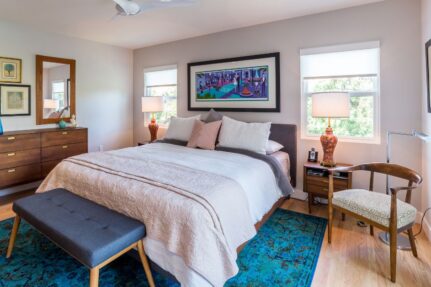 Master bedroom suite addition with a spacious sleeping area, hardwood floors, designer furnishings, abundant natural light, and a comfortable retreat-like atmosphere.