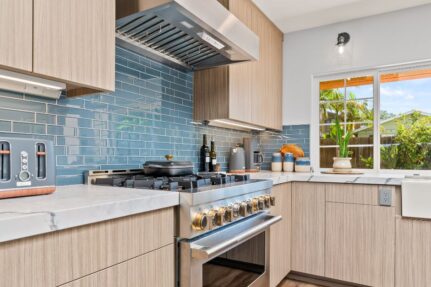 Kitchen backsplash design featuring blue subway tile, custom cabinetry, quartz countertops, and contemporary finishes that add color, texture, and visual interest to the space.
