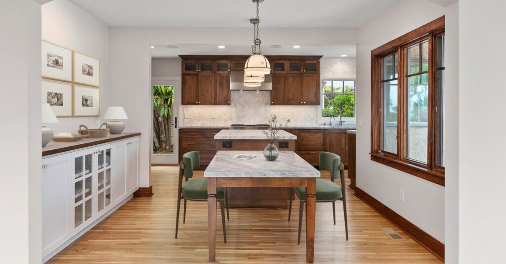 Luxury kitchen remodel featuring custom wood cabinetry, natural stone countertops, and premium materials selected through international product sourcing.