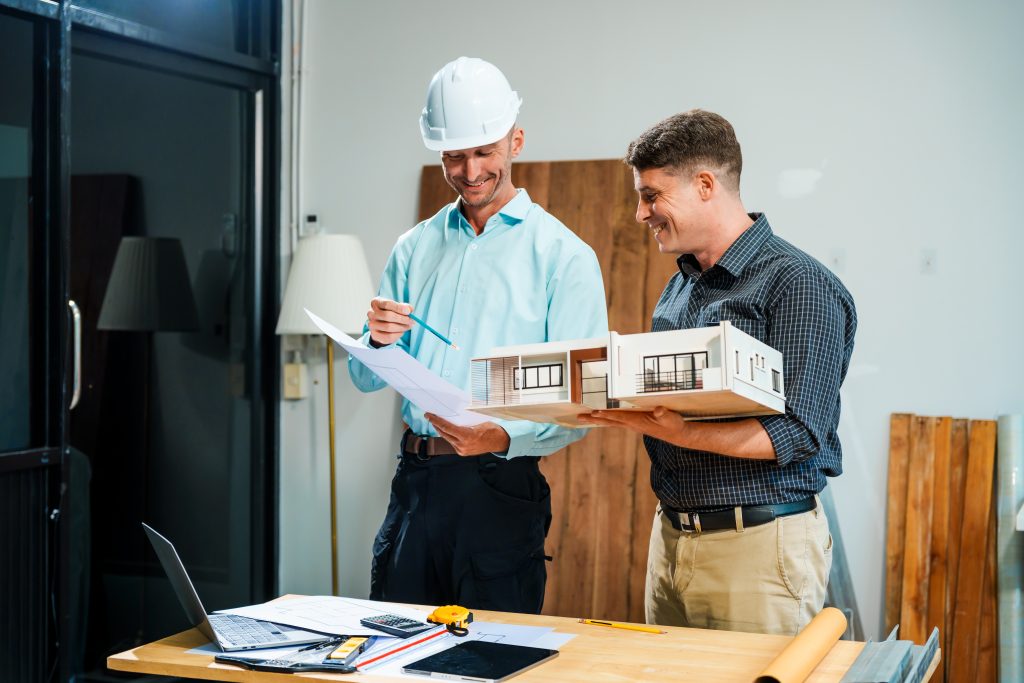 Amale engineer and a person discussing elevator project