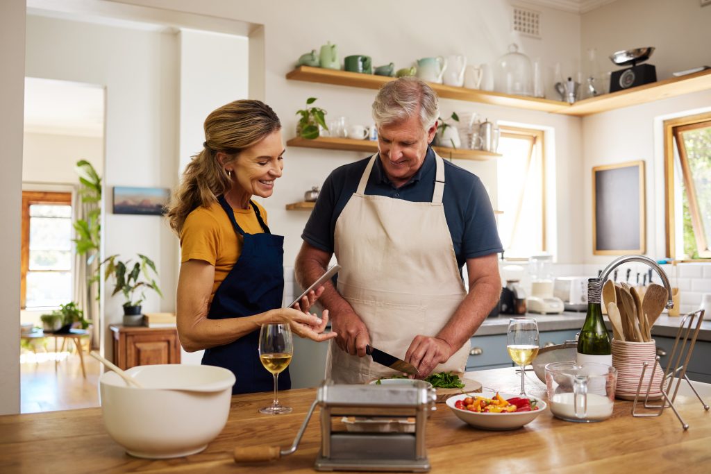 elderly couple cooking in kitchen