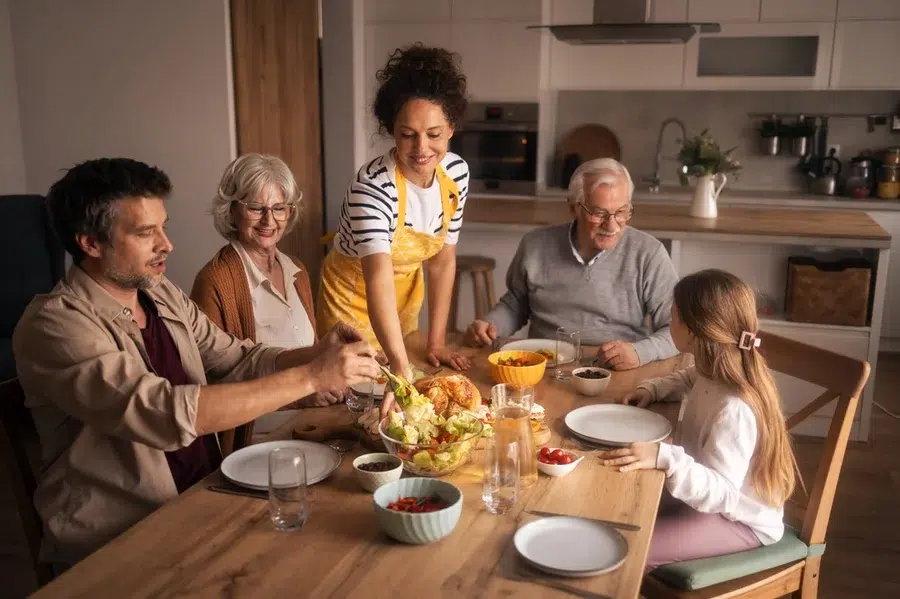 A multi-generational family sitting at the dinner table.