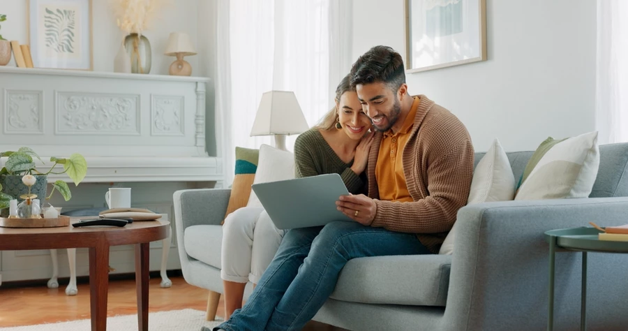 Couple looking at home renovation loan options on a laptop