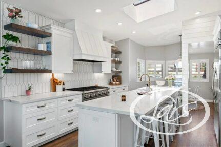 A bright, modern kitchen featuring white kitchen island and cabinetry