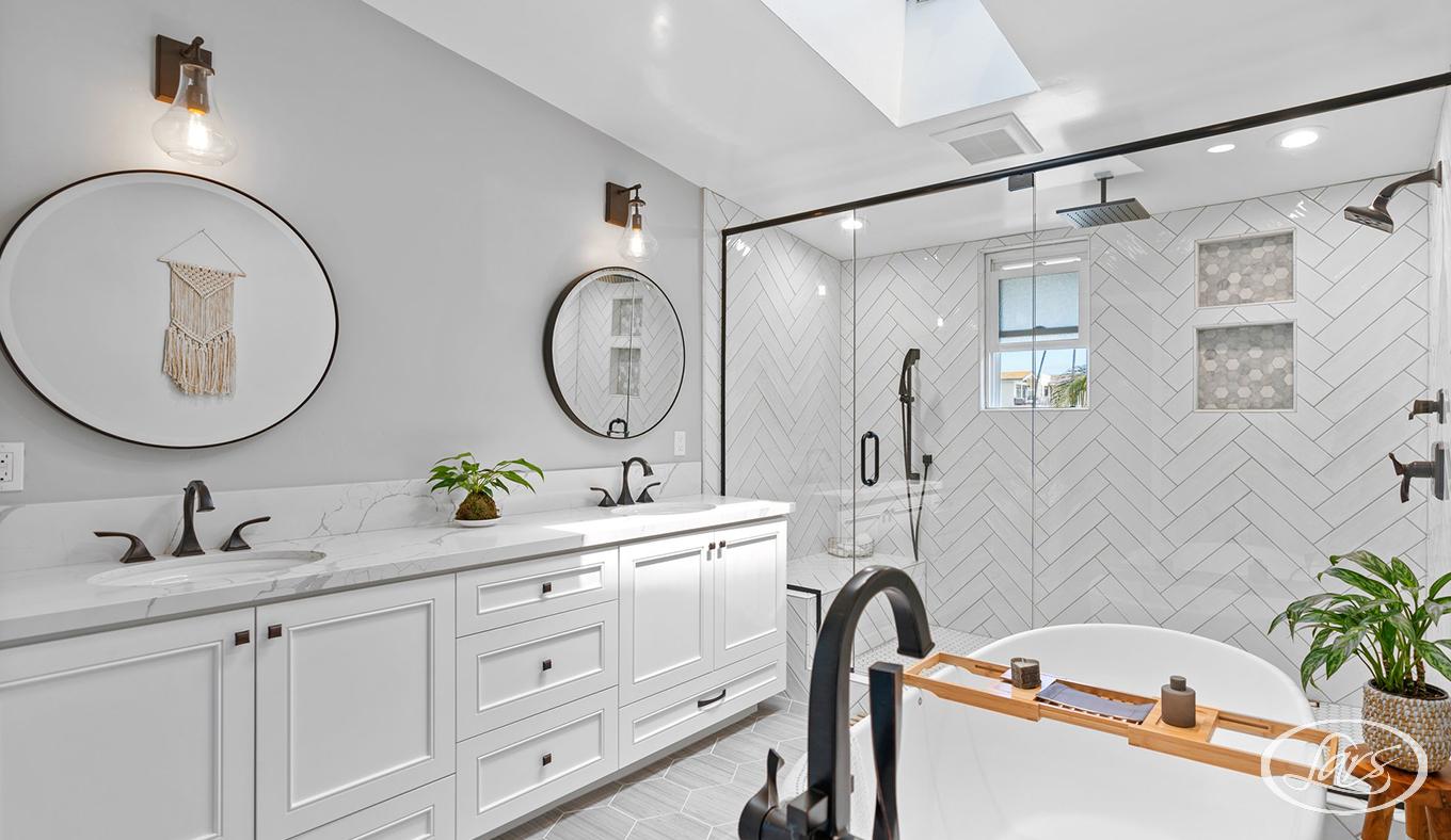 Newly remodeled bathroom in San Diego with white cabinets and floors.