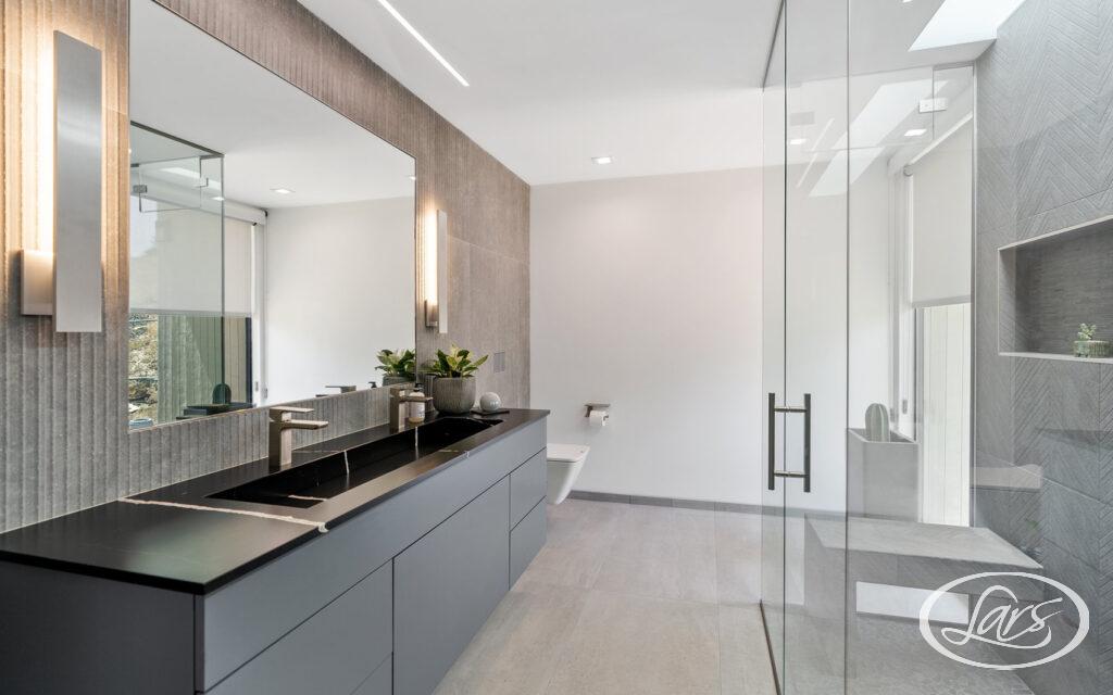 Newly renovated bathroom in San Diego with black and chrome finishes.