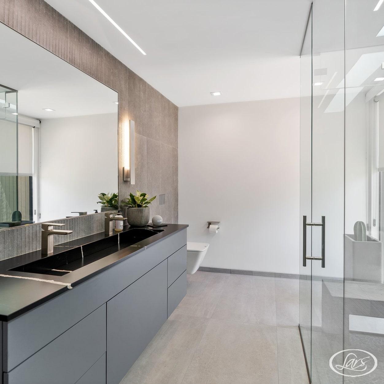 Newly renovated bathroom in San Diego with black and chrome finishes.