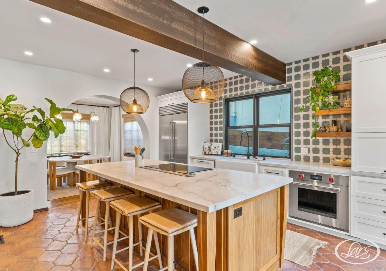 A beautiful Spanish styled kitchen with arched doorways and terracotta tiled flooring.