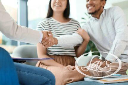 People shaking hands at a table in a modern office