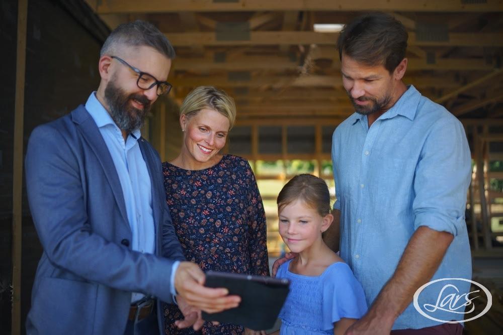 parents of young girl discussing new home project with builder 