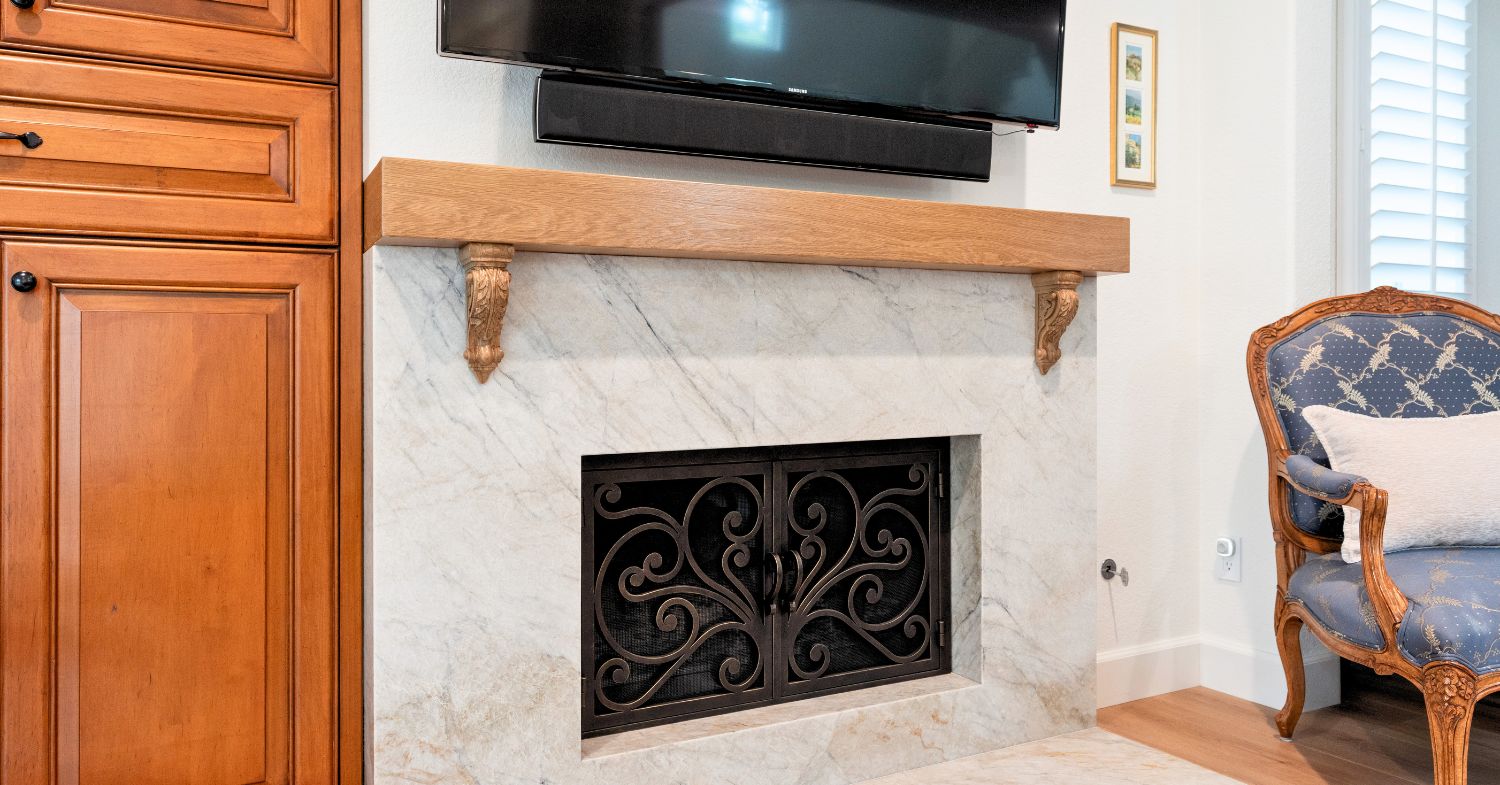 Carmel Valley bathroom remodel detail — marble countertop, polished chrome fixtures, beveled mirror, and plantation shutters in a primary bathroom by Lars Remodeling & Design
