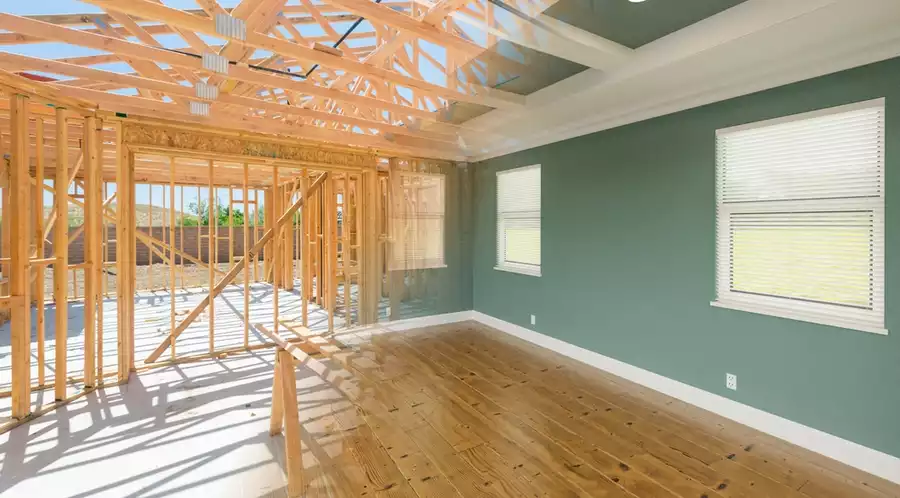 A visualization showing a stud wall transforming into a completed home remodel.