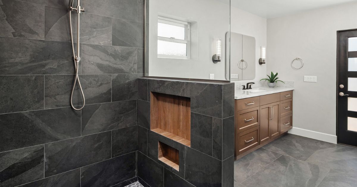 Modern accessible bathroom remodel with walk-in shower, floating niche details, and warm wood vanity cabinetry.