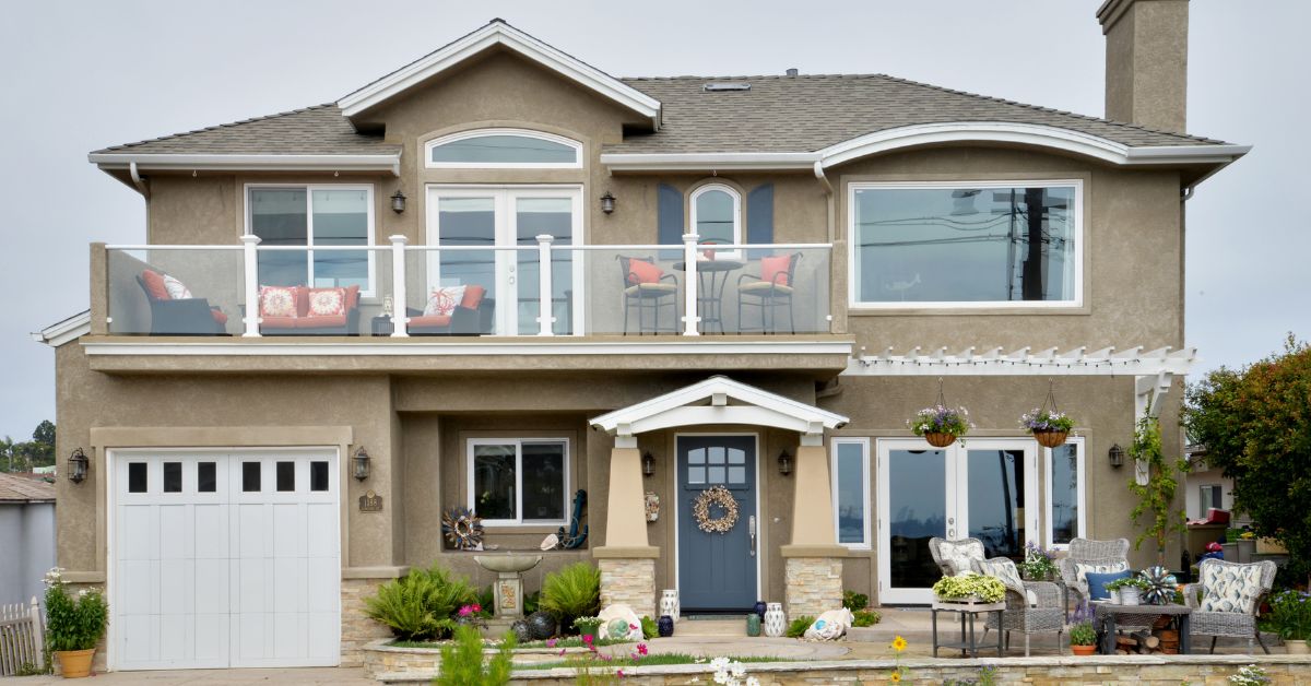 Backyard patio and exterior remodel with sliding glass doors, outdoor deck, and finished landscaping