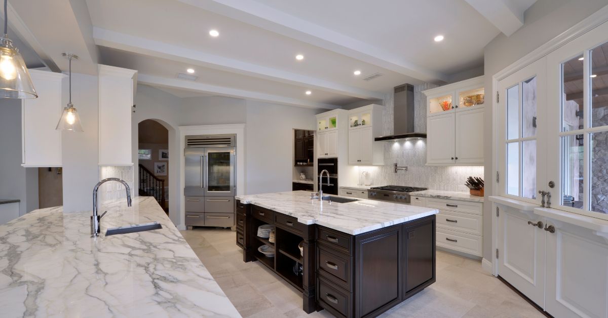 Luxury San Diego kitchen remodel with custom cabinetry, large marble island, and professionally managed construction execution