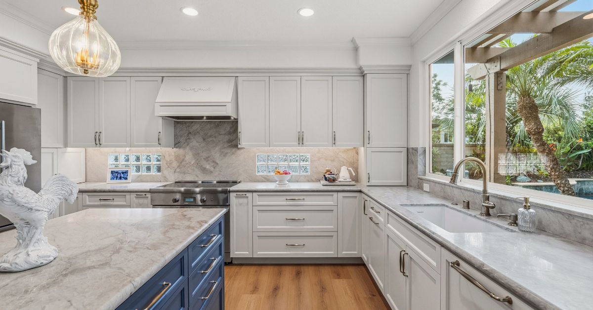 Homeowner reviewing design inspiration book and countertop samples during remodeling planning