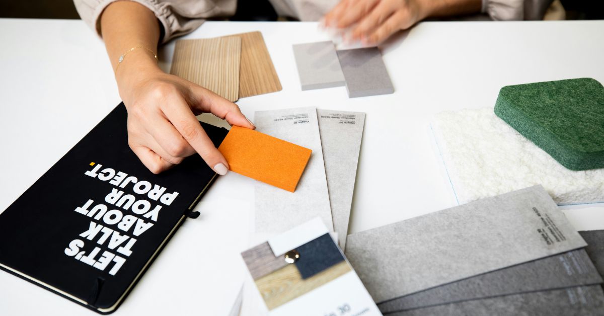 Interior designer reviewing finish samples, flooring materials, and product selections with a homeowner.