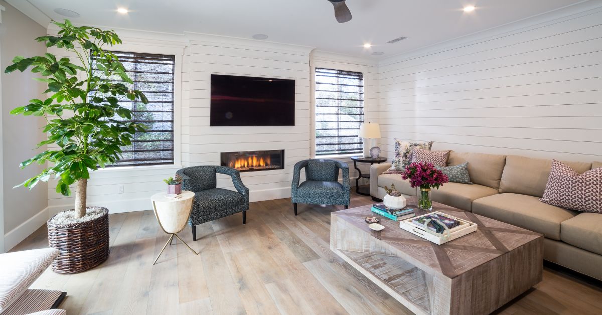 Modern remodeled San Diego living room with custom fireplace, neutral interior design, wide plank flooring, and comfortable seating