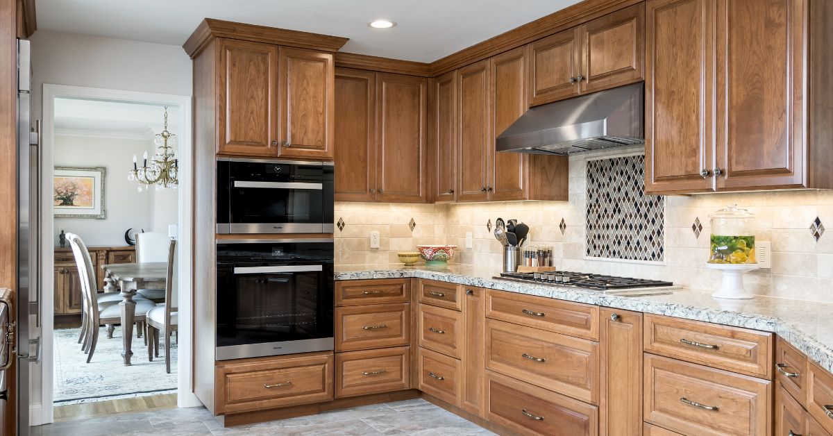 Homeowner reviewing unexpected remodeling costs and invoices while sitting inside an unfinished kitchen renovation.