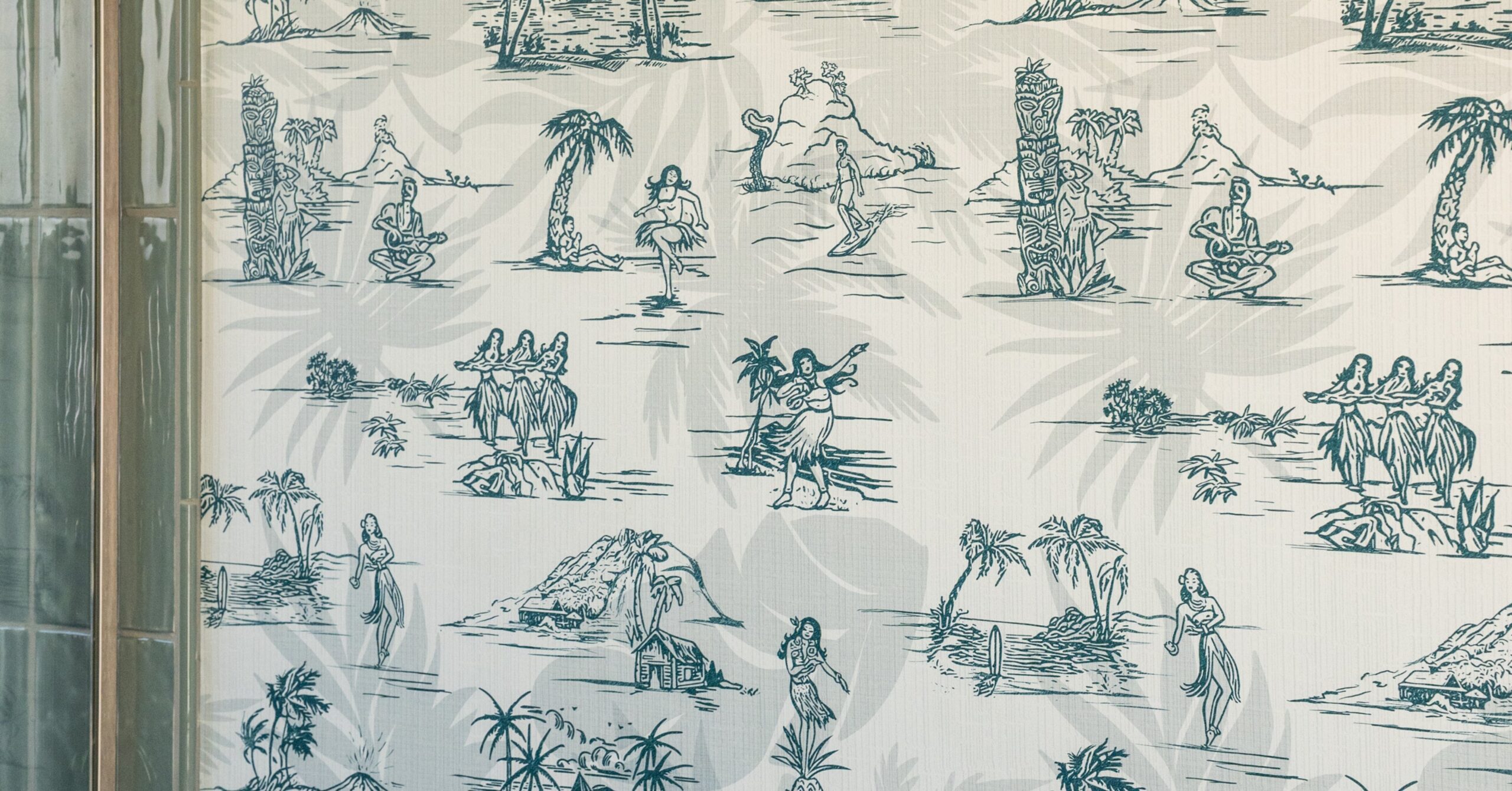Close-up of custom tropical-inspired wallpaper featuring hand-drawn island and surf illustrations in a modern guest bathroom.