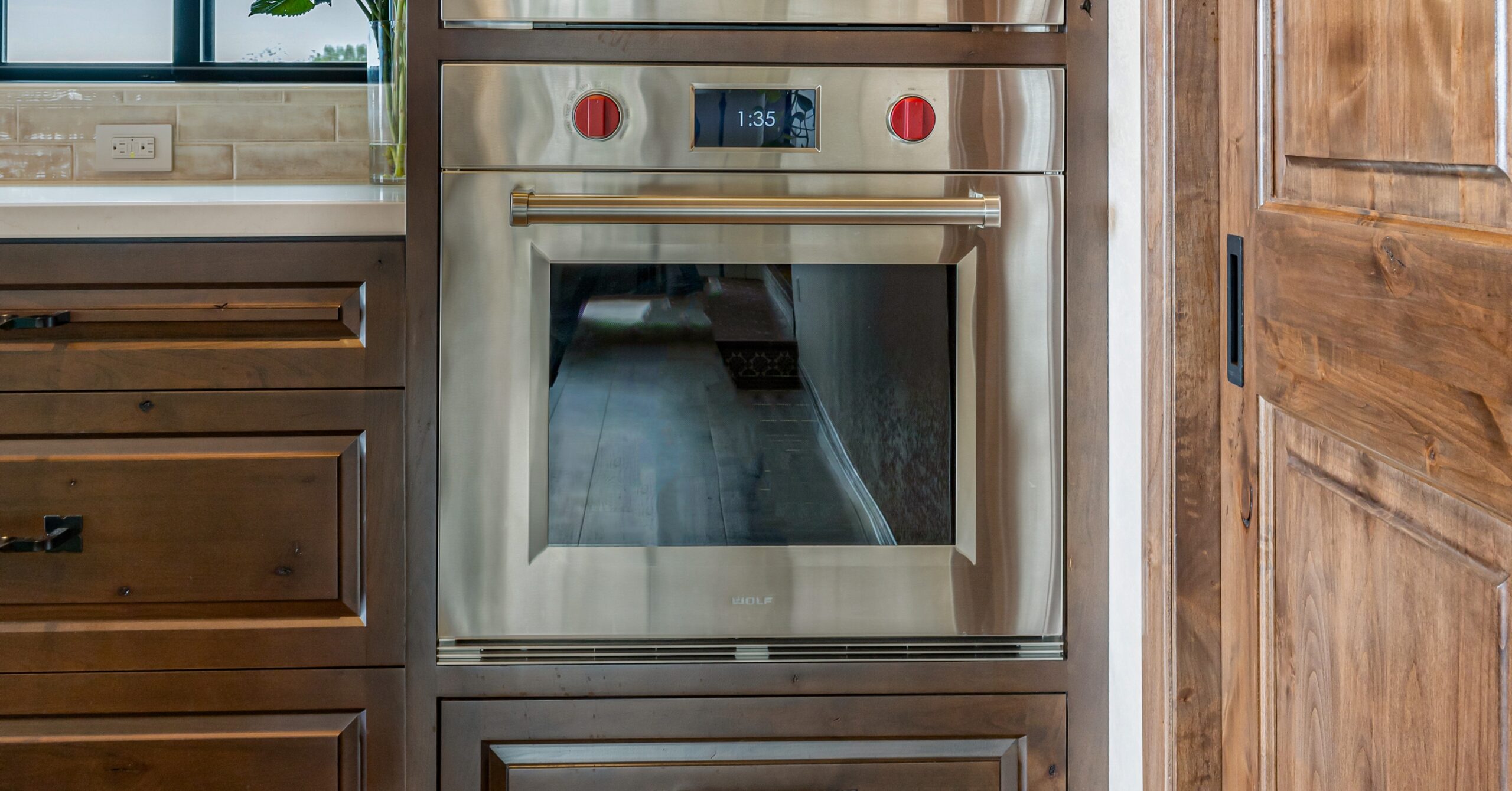 Wolf speed oven integrated into custom wood cabinetry in a Vista kitchen remodel designed around function-first cooking, improved storage, and personalized kitchen workflow.