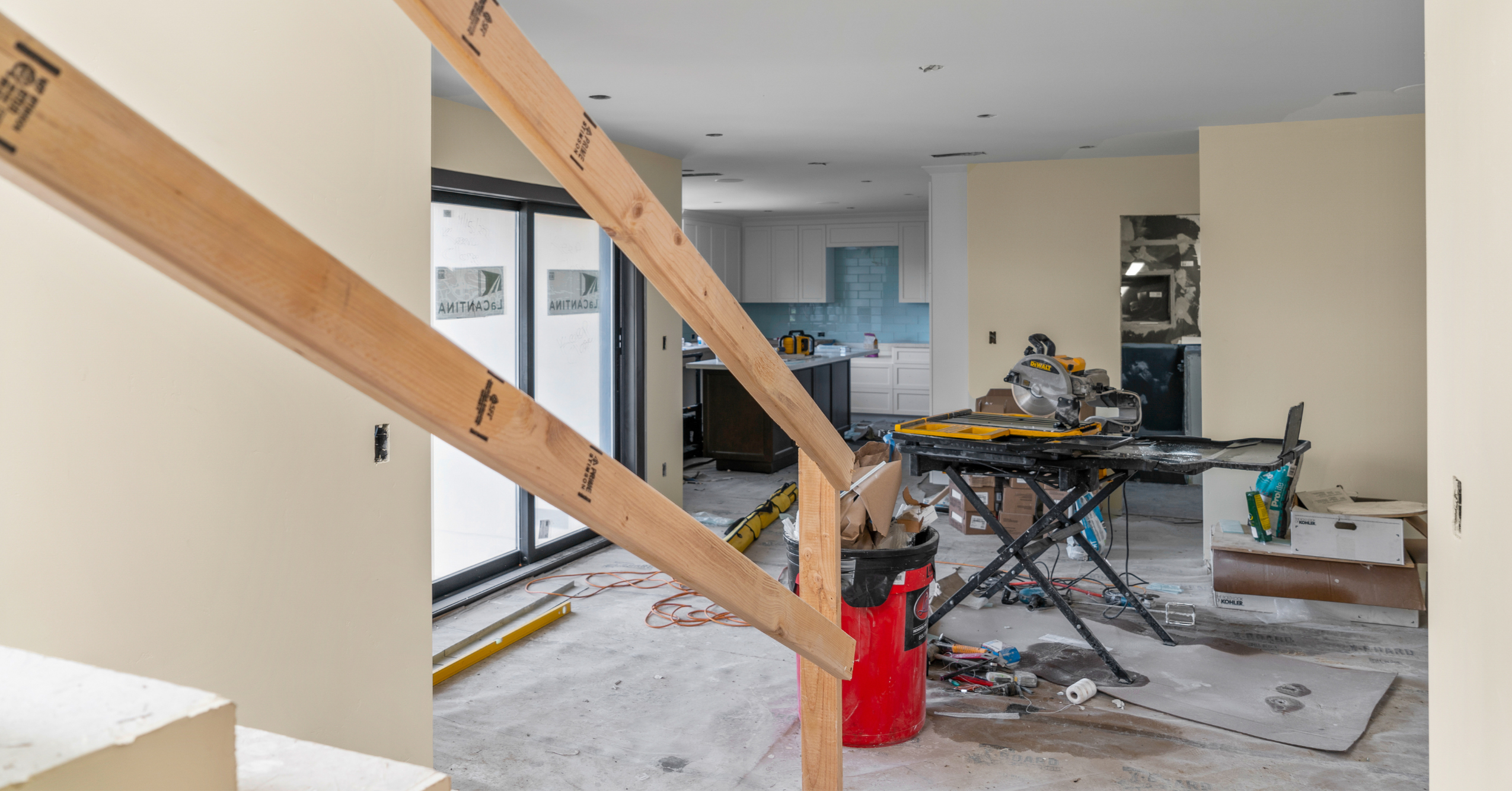 Whole-home remodel under construction with framing, tools, unfinished walls, and kitchen renovation work in progress.