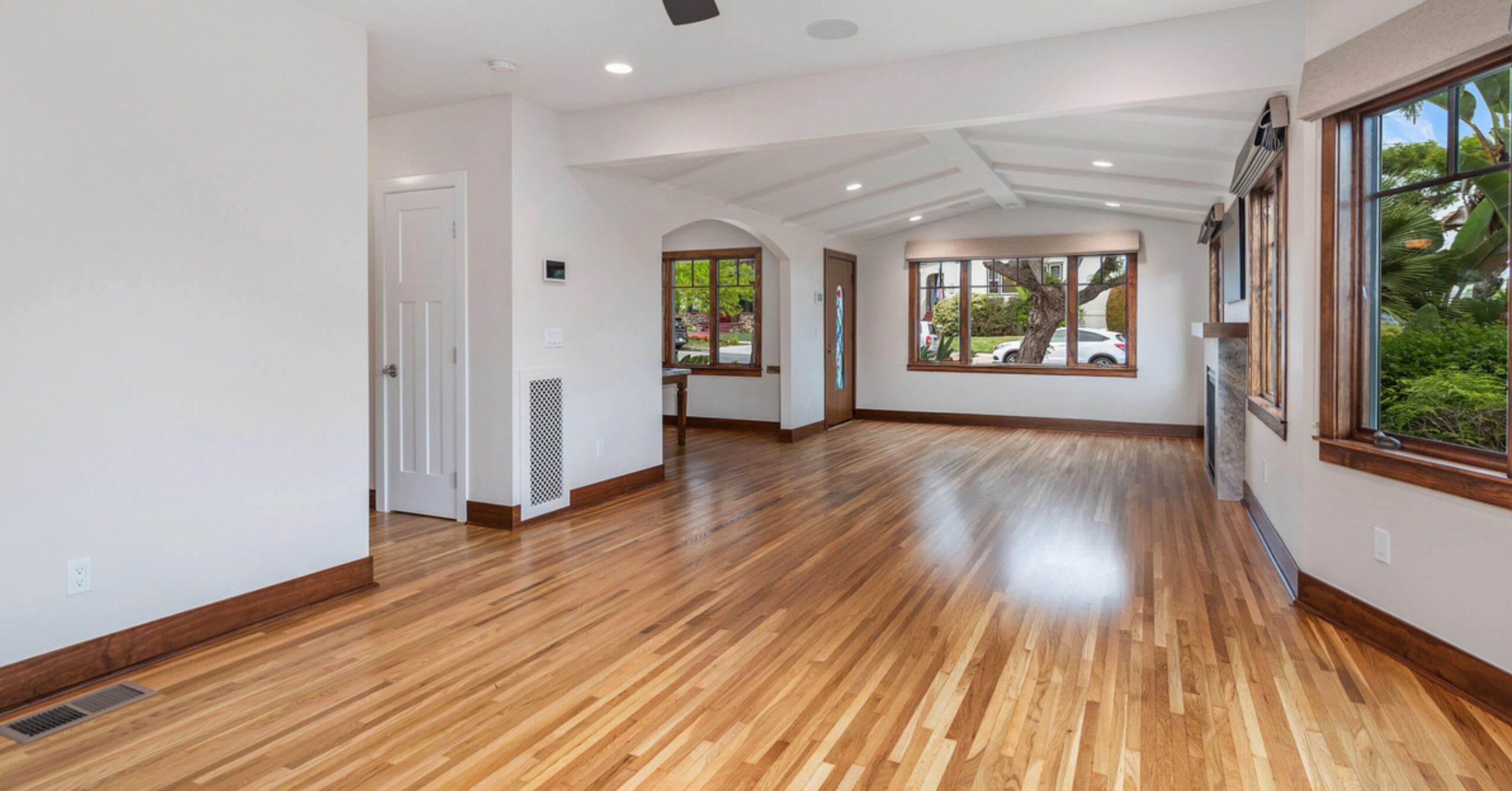 Open-concept living area in a remodeled South Park Craftsman featuring restored hardwood floors, expanded living space, and improved interior flow.