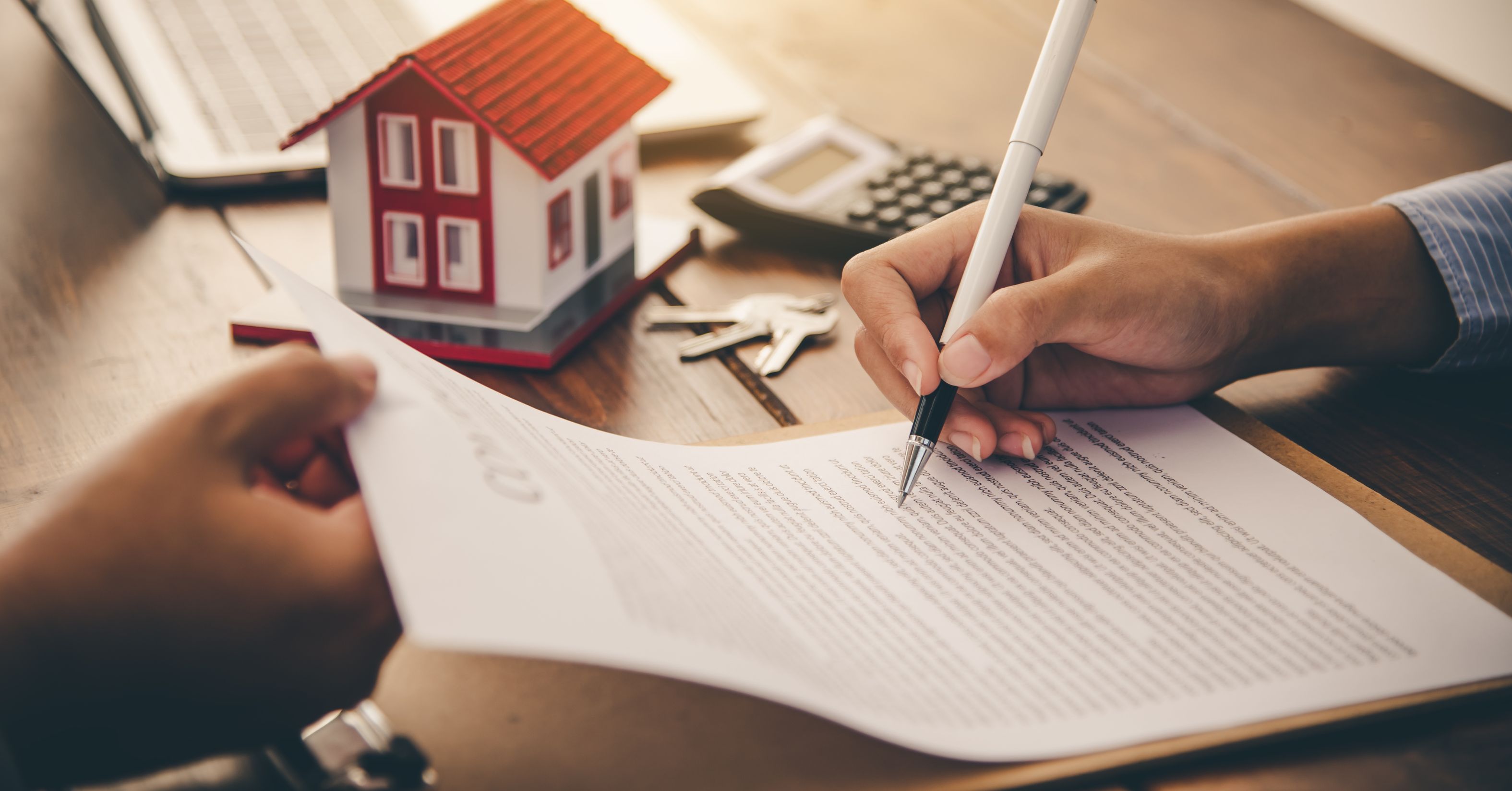 Homeowner signing a home improvement contract before starting a remodeling project.