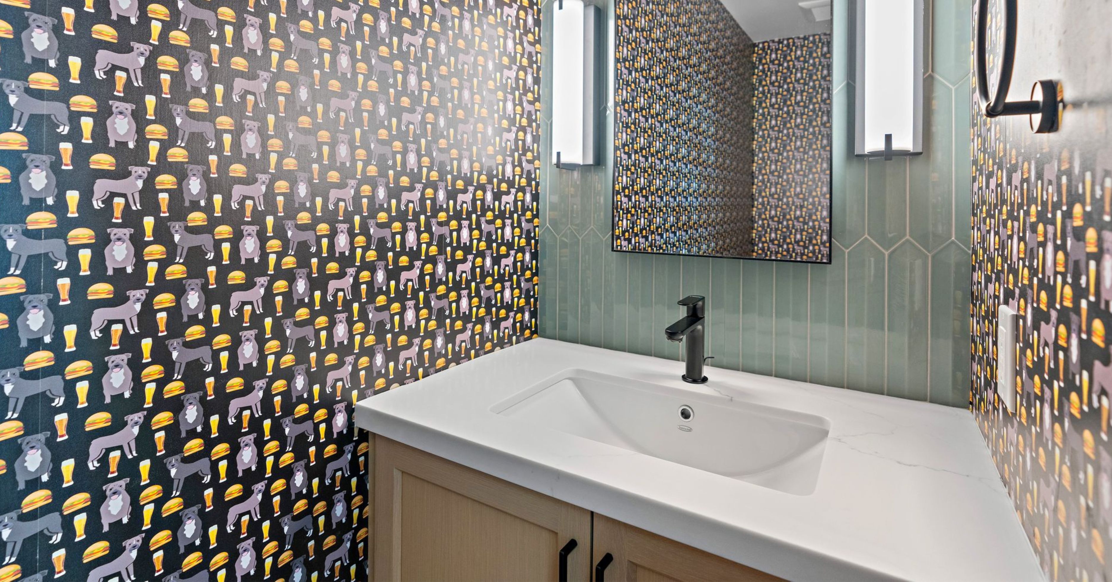 Designer powder room with custom wallpaper, green vertical tile accent wall, floating vanity, and modern black fixtures.