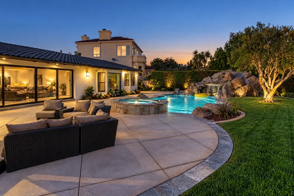 La Jolla outdoor living area with a patio, pool, spa, and sliding glass doors.