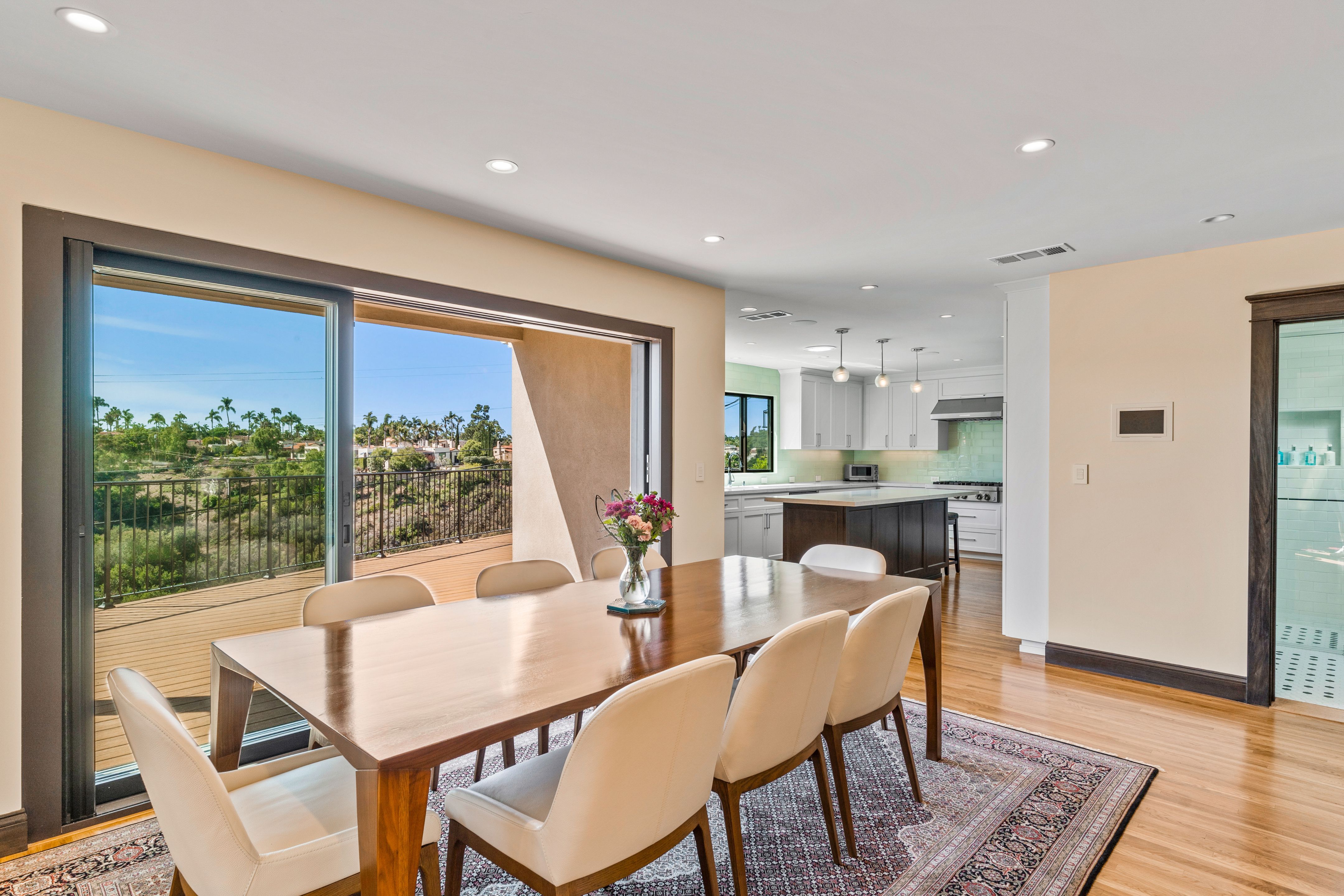 Dining addition with hardwood floors, wide glass doors and direct access to the canyon-facing deck