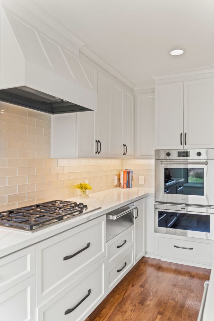Three white dimmer switches provide adjustable lighting control on a neutral wall in the remodeled La Mesa home.