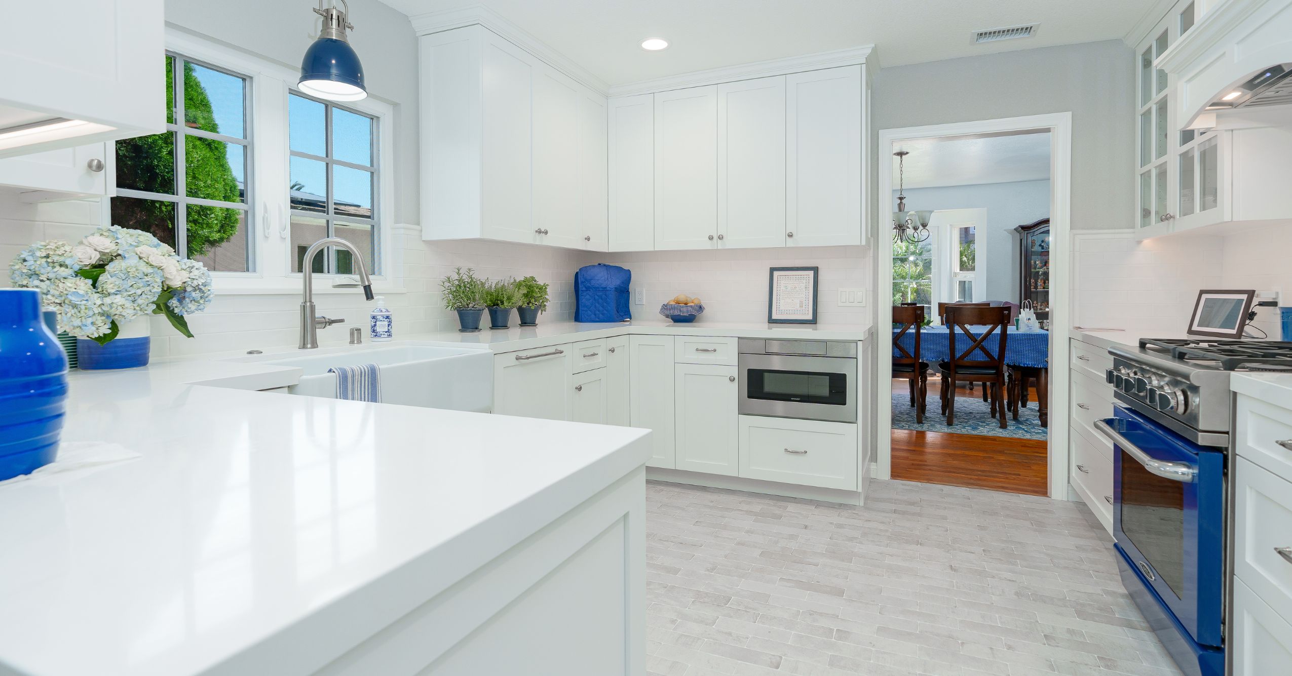  Point Loma kitchen remodel with white shaker cabinetry, quartz counters, blue range, and glass-front uppers.