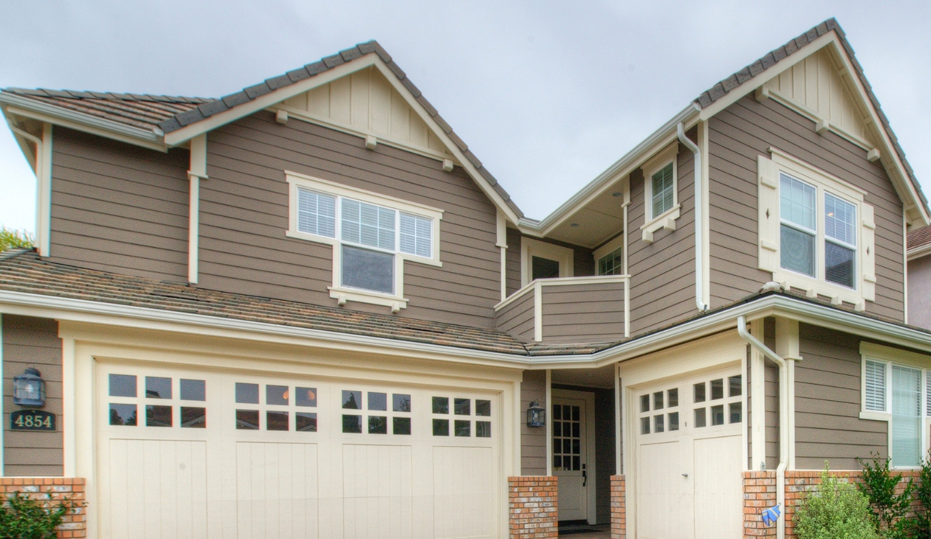 Two-story whole-home remodel in Carmel Valley with gray siding, tile roof and second-story balcony addition