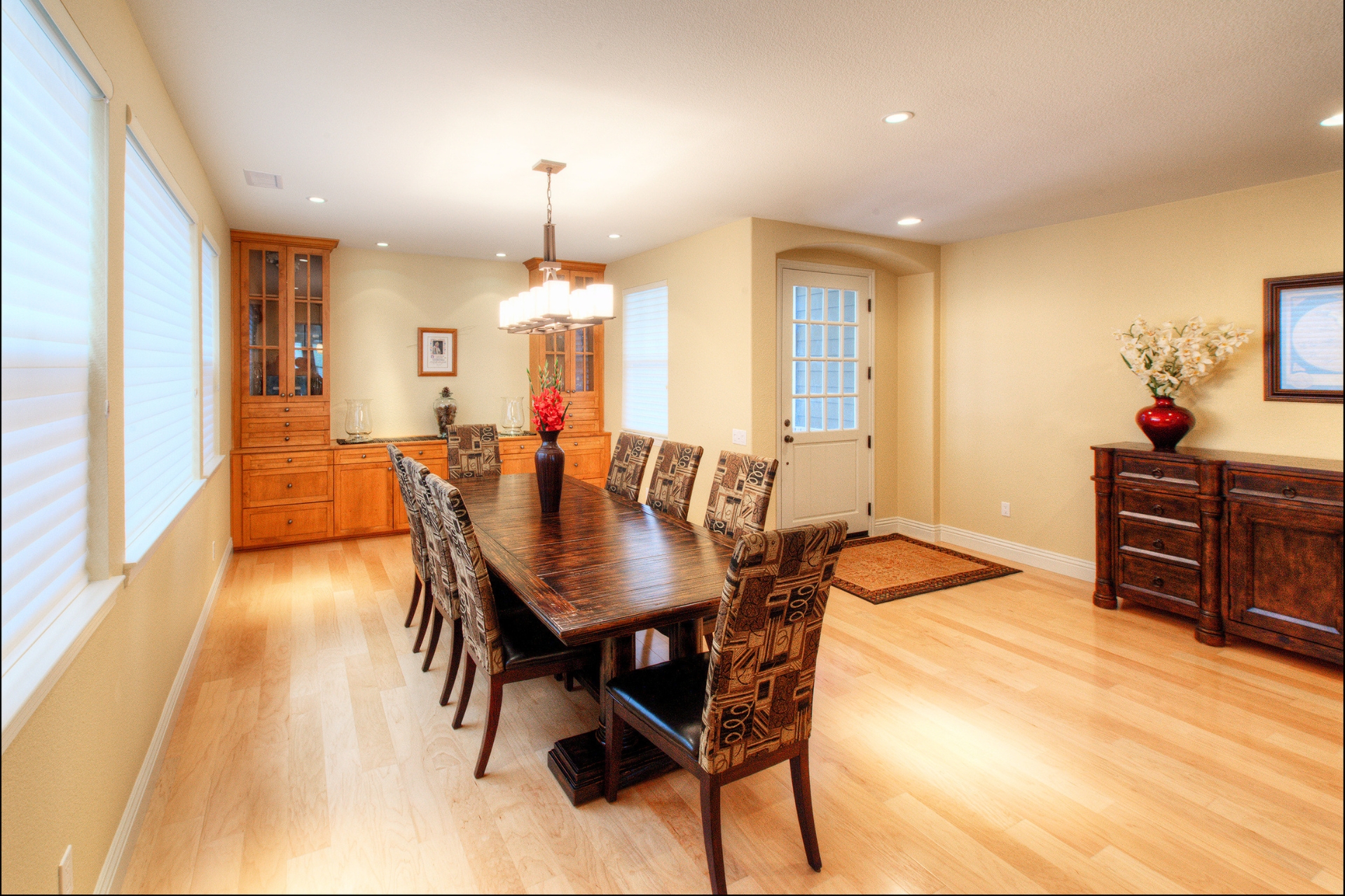 Dining room with built-in wood hutch, hardwood floors, chandelier and glass-paned exterior door
